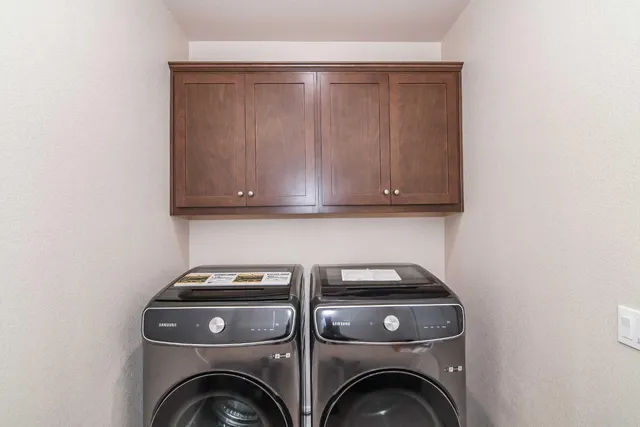 an empty room with a window and ceiling fan