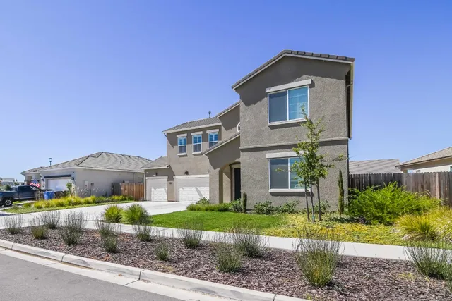 an aerial view of a house with a swimming pool