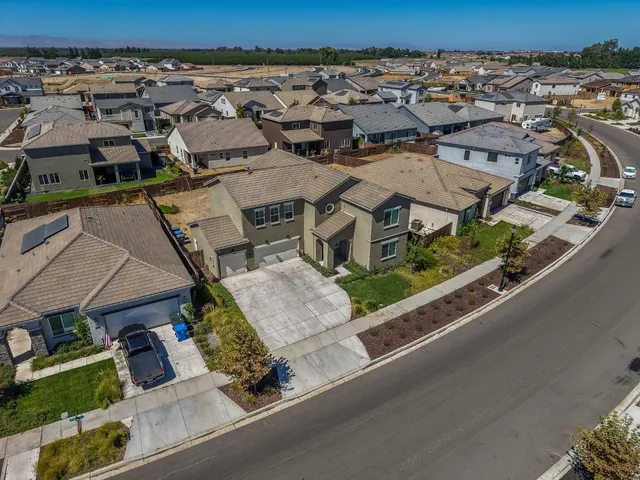 an aerial view of a house with a swimming pool