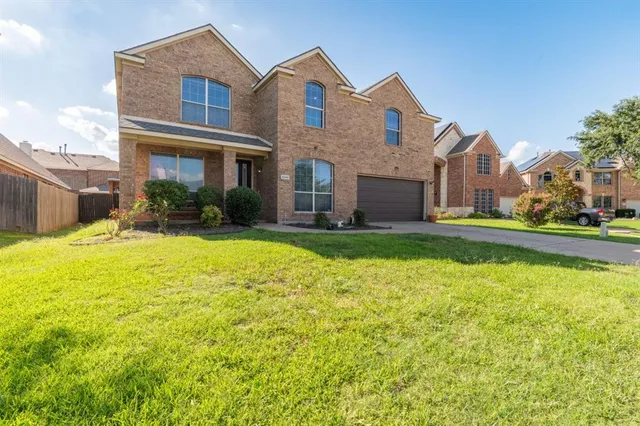 a front view of a house with a yard table and chairs