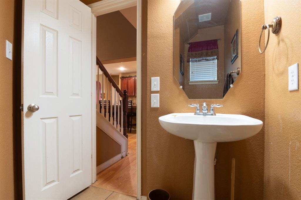 2248 Condor Street Grand Prairie, TX 75052 - Photo 13 of 25 a bathroom with a sink and a mirror