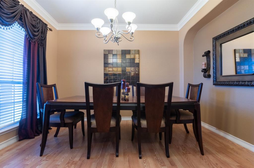 2248 Condor Street Grand Prairie, TX 75052 - Photo 15 of 25 a view of a dining room with furniture wooden floor and chandelier