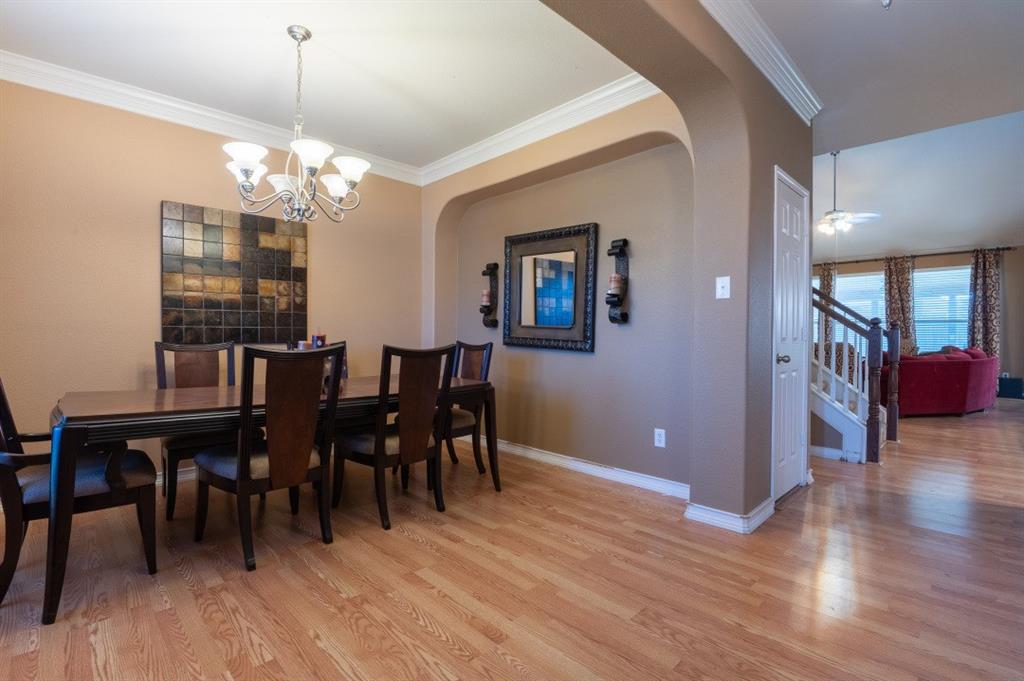 2248 Condor Street Grand Prairie, TX 75052 - Photo 16 of 25 a view of a dining room with furniture and chandelier