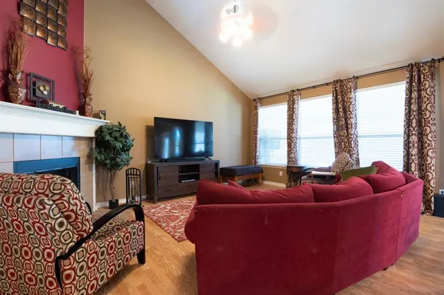 a living room with furniture a large window and a flat screen tv