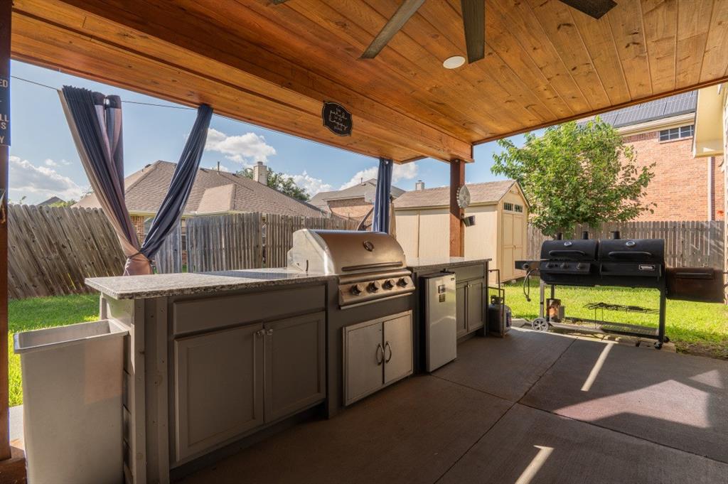 2248 Condor Street Grand Prairie, TX 75052 - Photo 3 of 25 a kitchen with stainless steel appliances granite countertop a stove a sink and a refrigerator