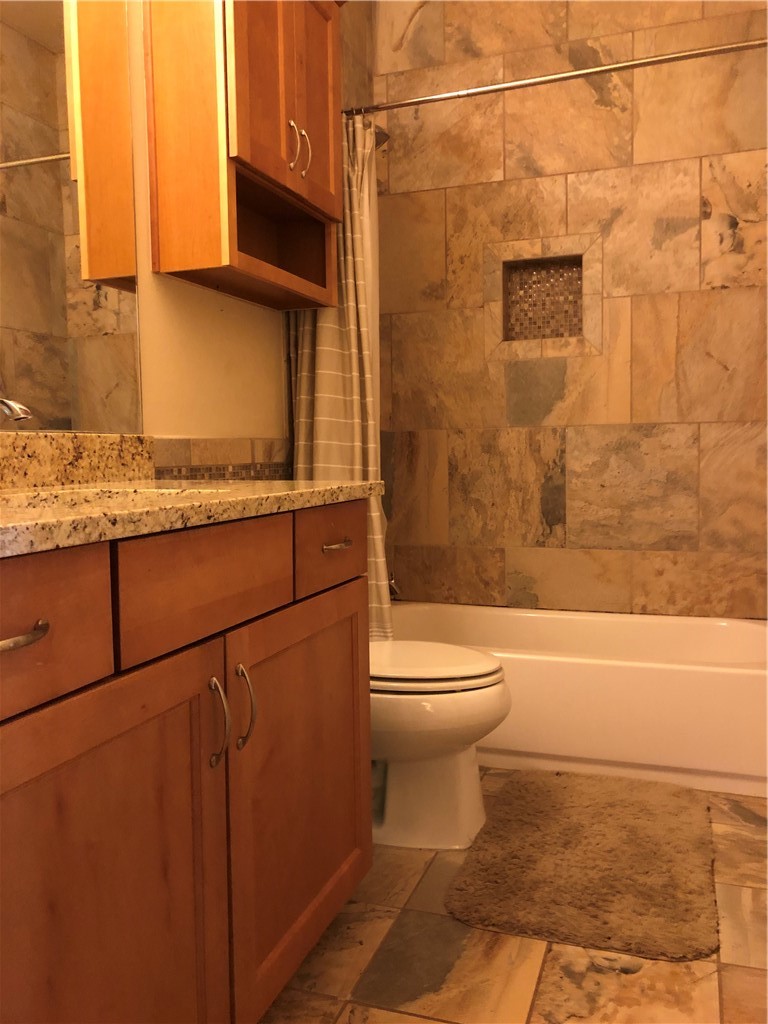 1303 Casey Street, Unit A Austin, TX 78745 - Photo 15 of 16 a bathroom with a toilet a sink and a shower
