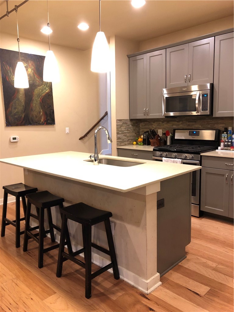 1303 Casey Street, Unit A Austin, TX 78745 - Photo 2 of 16 a kitchen with a sink cabinets and wooden floor