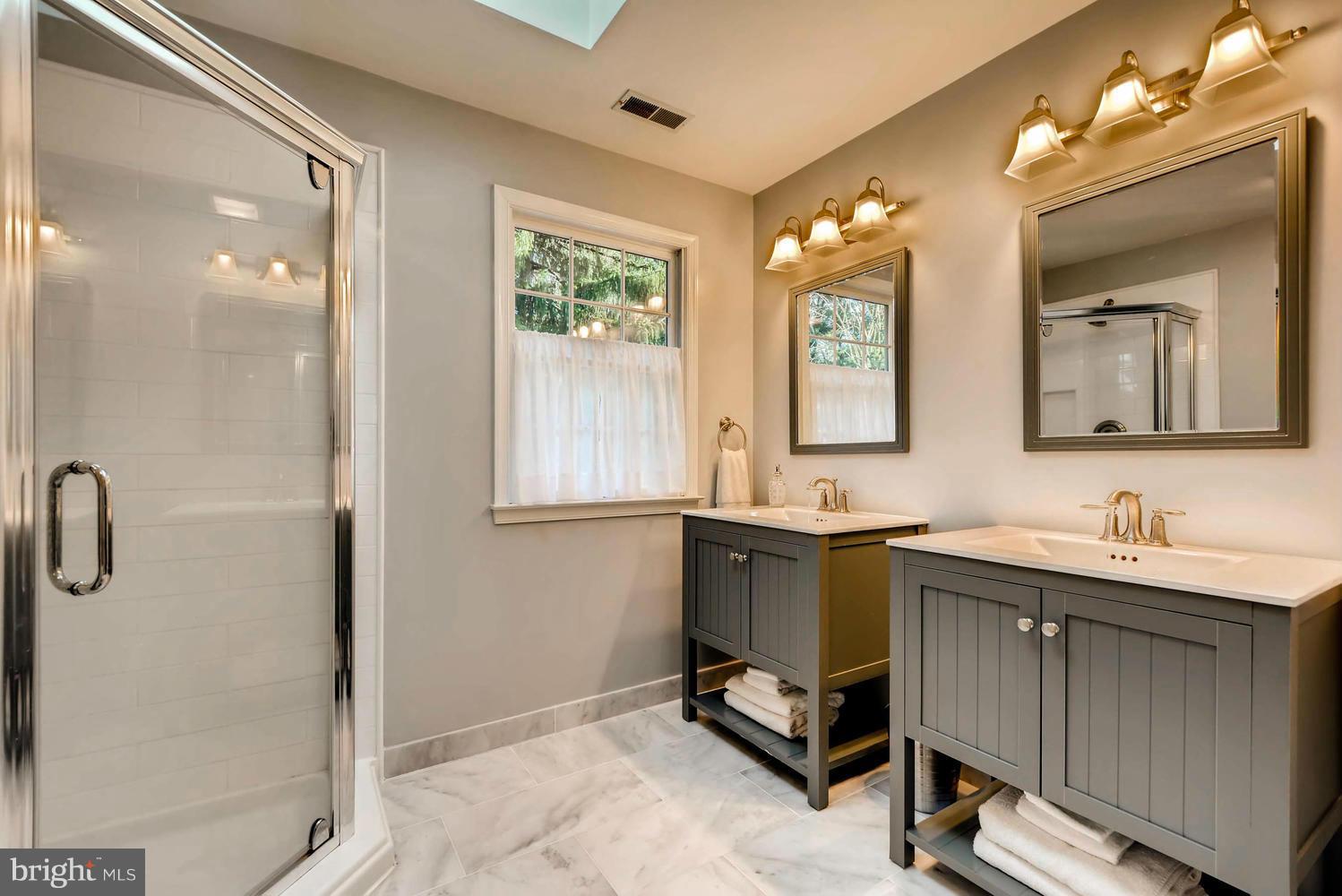1034 Monkton Road Monkton, MD 21111 - Photo 16 of 30 a en suite bathroom with a double vanity sink a mirror and a shower