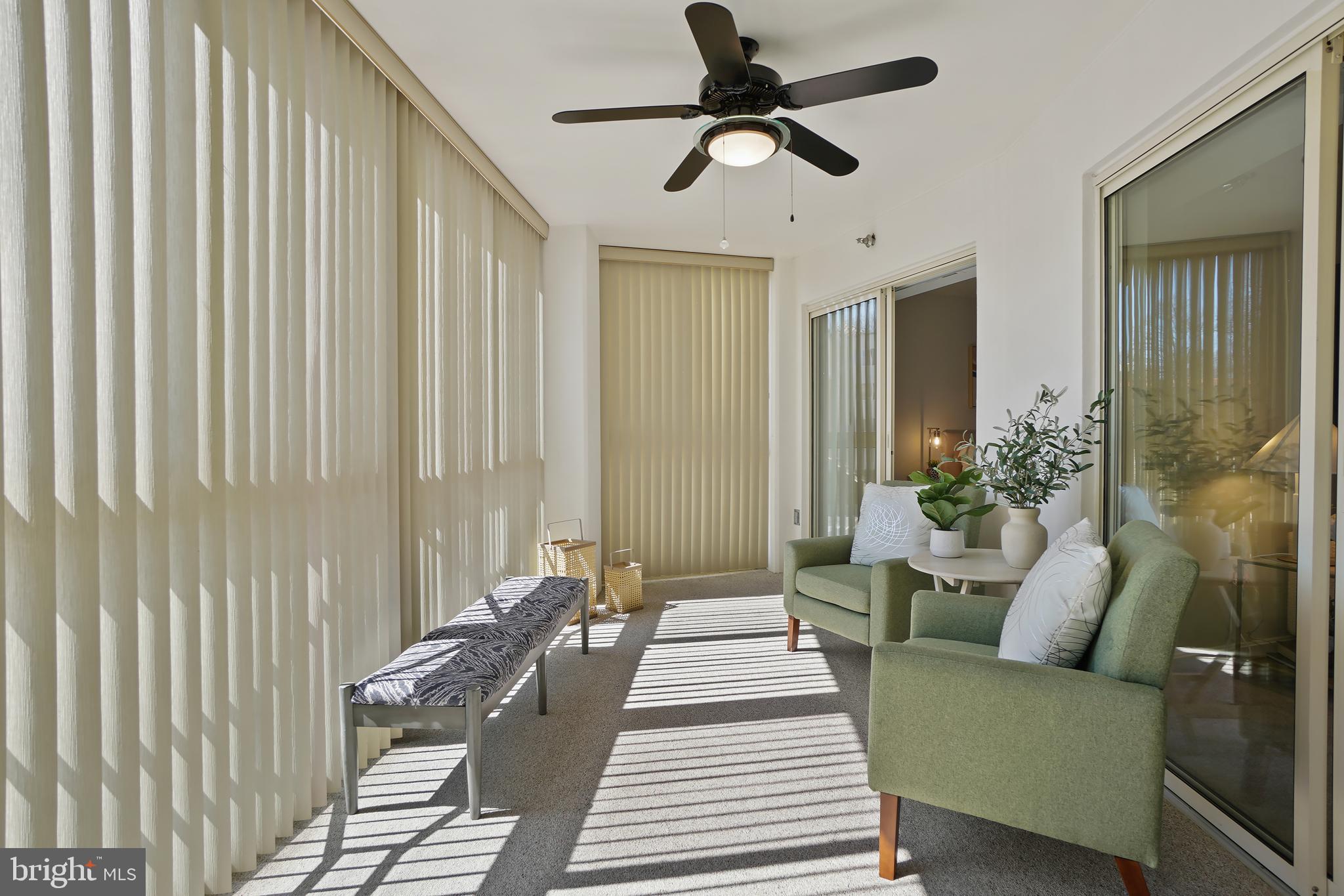 14801 Pennfield Circle, Unit 306 Silver Spring, MD 20906 - Photo 10 of 45 a living room with furniture and a chandelier