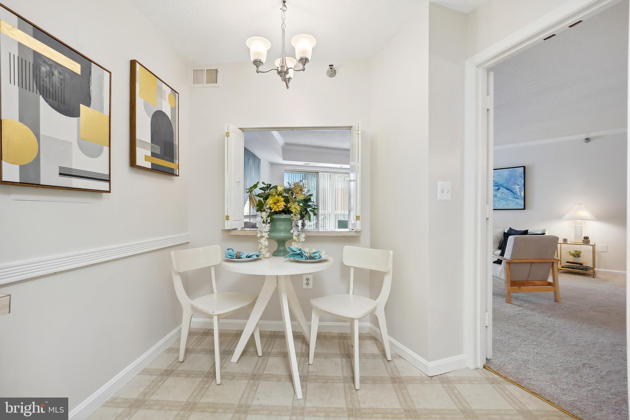 14801 Pennfield Circle, Unit 306 Silver Spring, MD 20906 - Photo 14 of 45 a dining room with furniture a livingroom and chandelier
