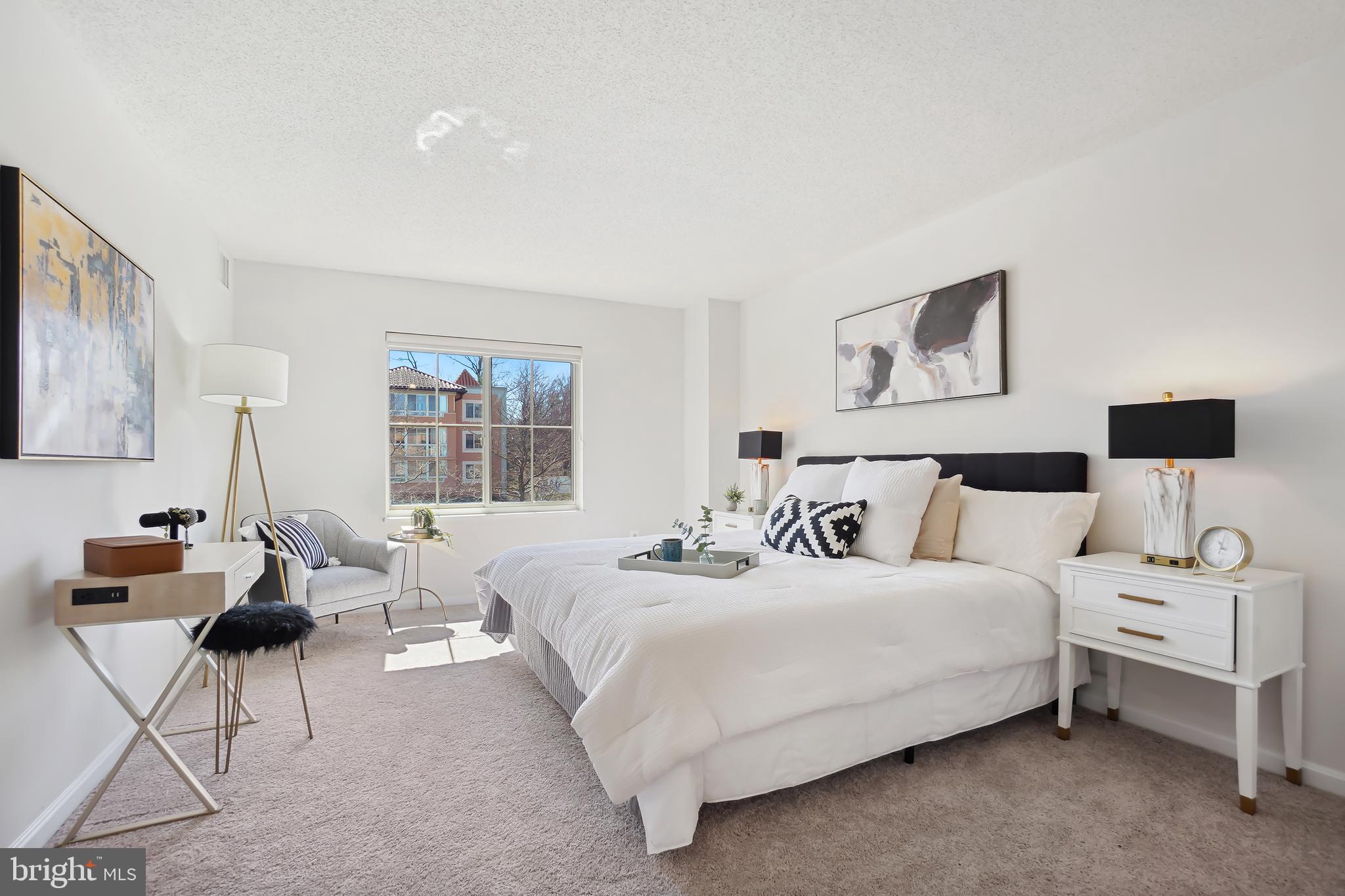 14801 Pennfield Circle, Unit 306 Silver Spring, MD 20906 - Photo 15 of 45 a bedroom with a bed and a couch