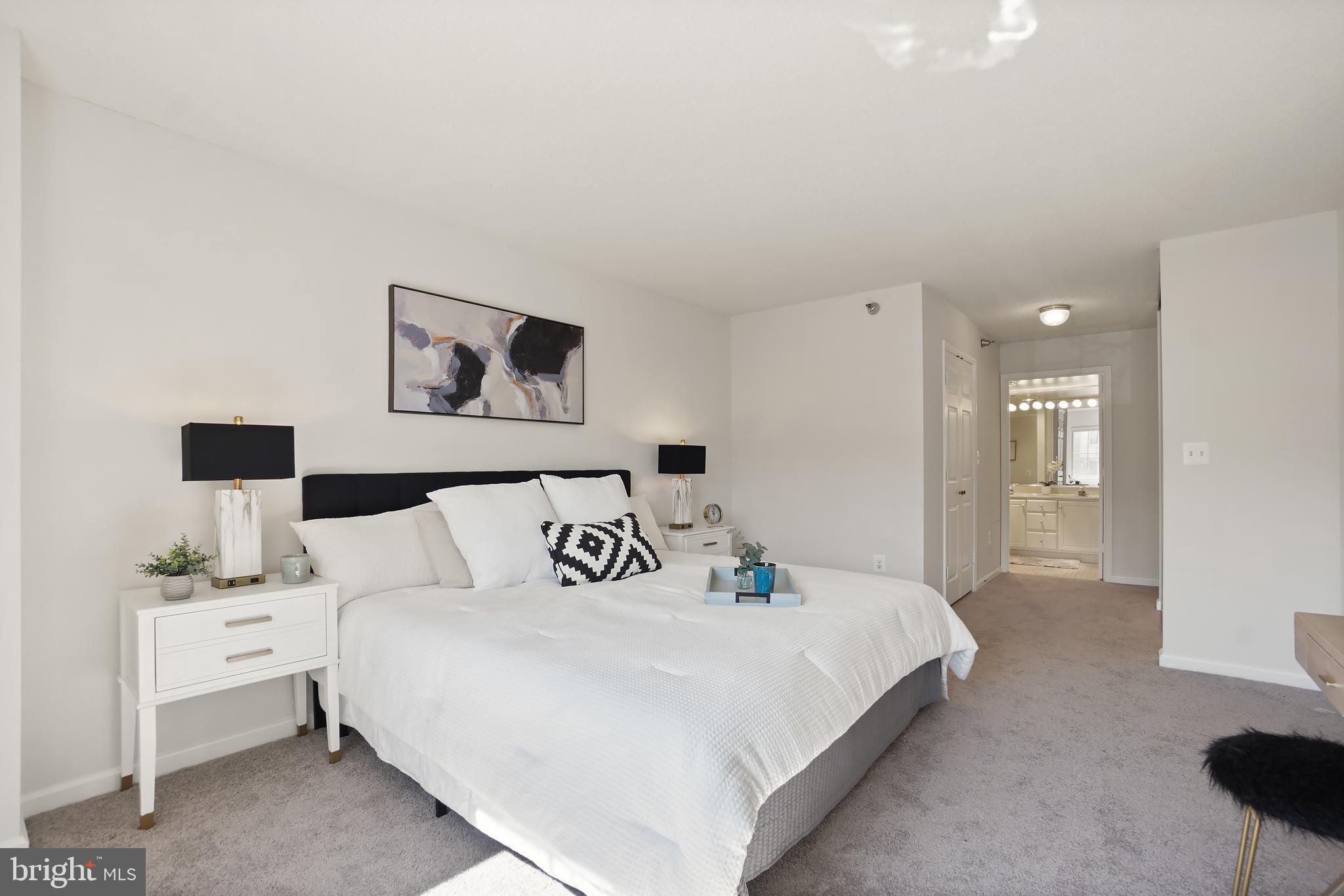 14801 Pennfield Circle, Unit 306 Silver Spring, MD 20906 - Photo 16 of 45 a bedroom with bed and a night stand