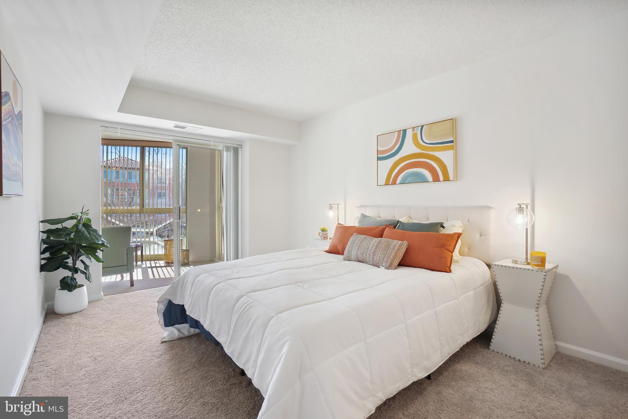 14801 Pennfield Circle, Unit 306 Silver Spring, MD 20906 - Photo 21 of 45 a bedroom with a bed and a potted plant