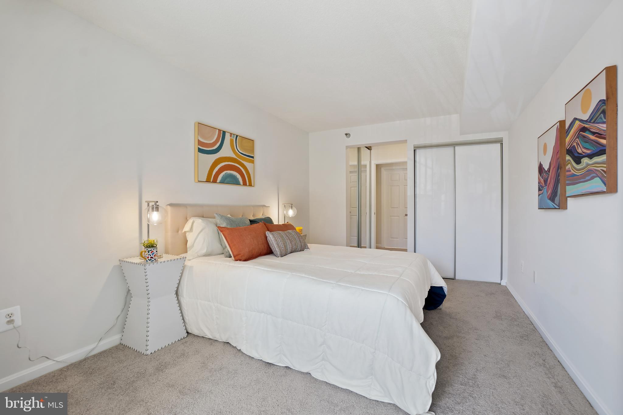 14801 Pennfield Circle, Unit 306 Silver Spring, MD 20906 - Photo 22 of 45 a bedroom with a bed and a painting on the wall