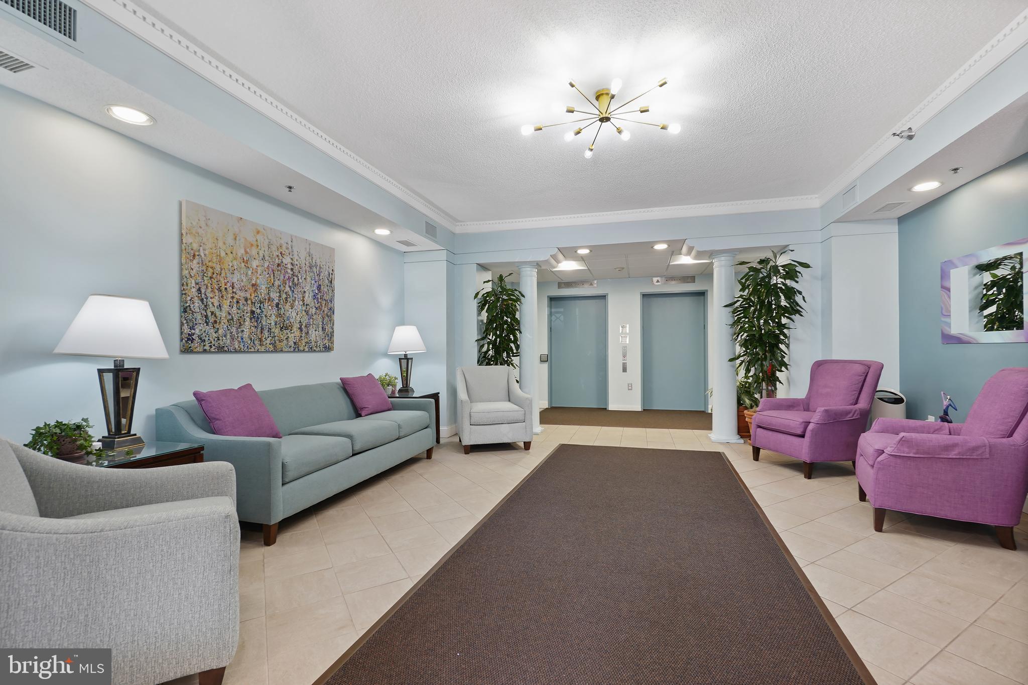 14801 Pennfield Circle, Unit 306 Silver Spring, MD 20906 - Photo 26 of 45 a living room with furniture and a chandelier