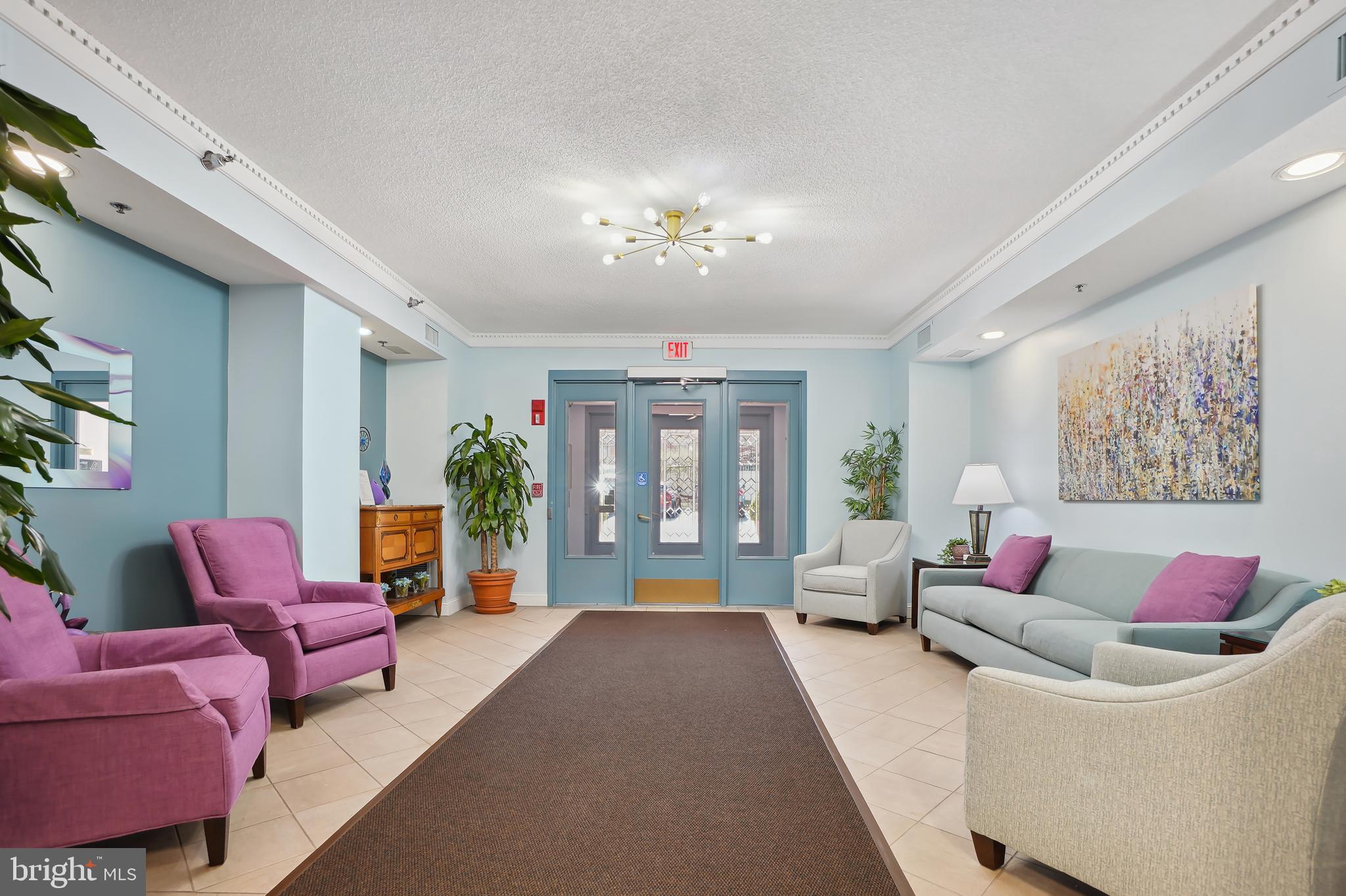 14801 Pennfield Circle, Unit 306 Silver Spring, MD 20906 - Photo 27 of 45 a living room with furniture flowerpot and a chandelier
