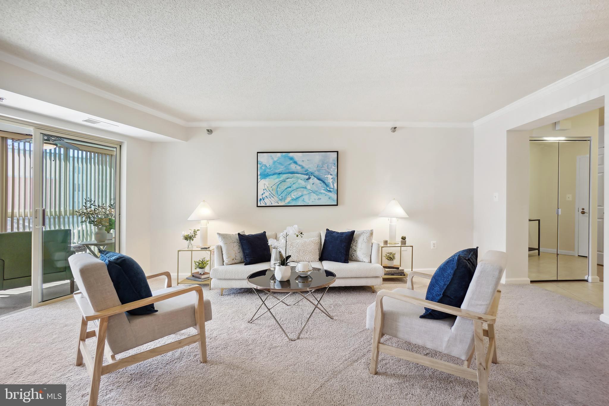 14801 Pennfield Circle, Unit 306 Silver Spring, MD 20906 - Photo 5 of 45 a living room with furniture and a large window