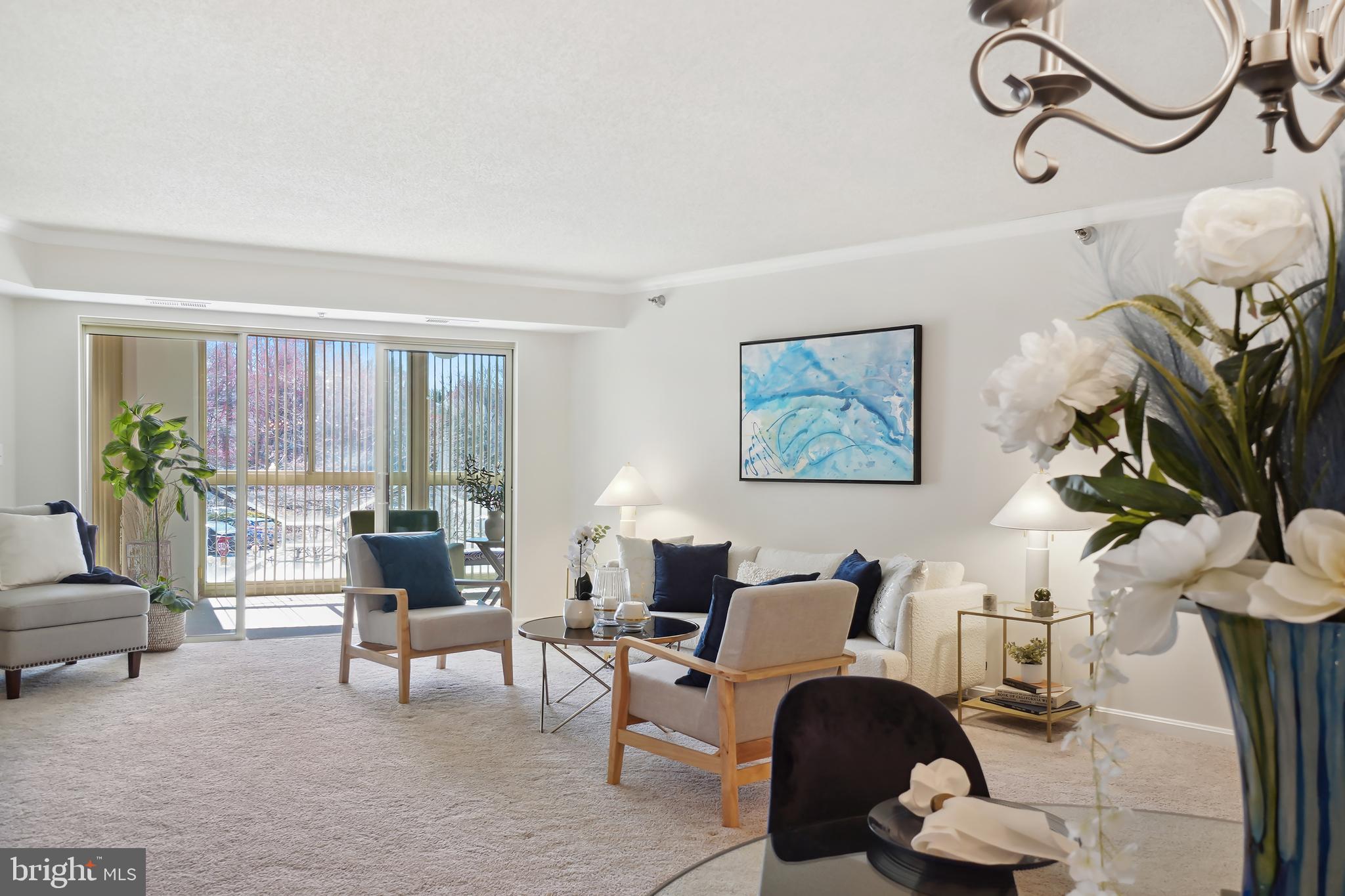 14801 Pennfield Circle, Unit 306 Silver Spring, MD 20906 - Photo 6 of 45 a living room with furniture a rug and a floor to ceiling window