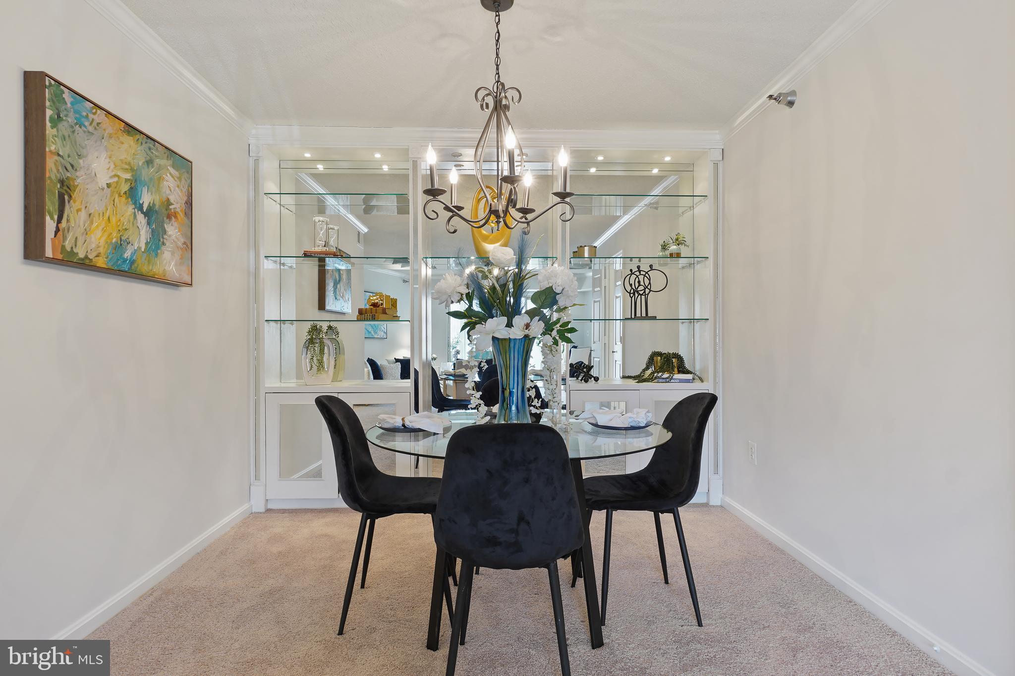 14801 Pennfield Circle, Unit 306 Silver Spring, MD 20906 - Photo 7 of 45 a view of a dining room with furniture and chandelier