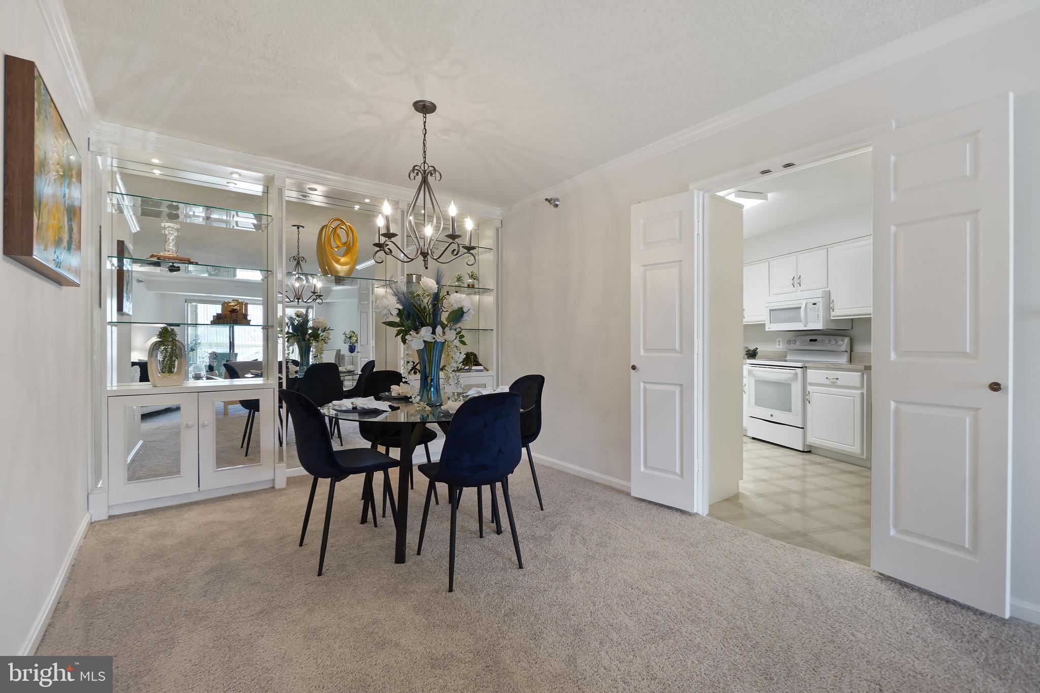14801 Pennfield Circle, Unit 306 Silver Spring, MD 20906 - Photo 8 of 45 a view of a dining room with furniture and chandelier