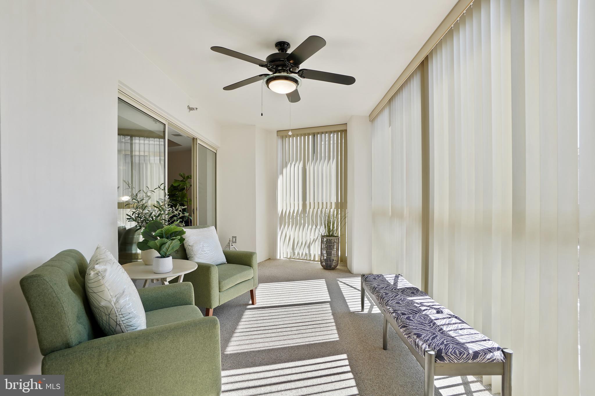 14801 Pennfield Circle, Unit 306 Silver Spring, MD 20906 - Photo 9 of 45 a living room with furniture and a chandelier