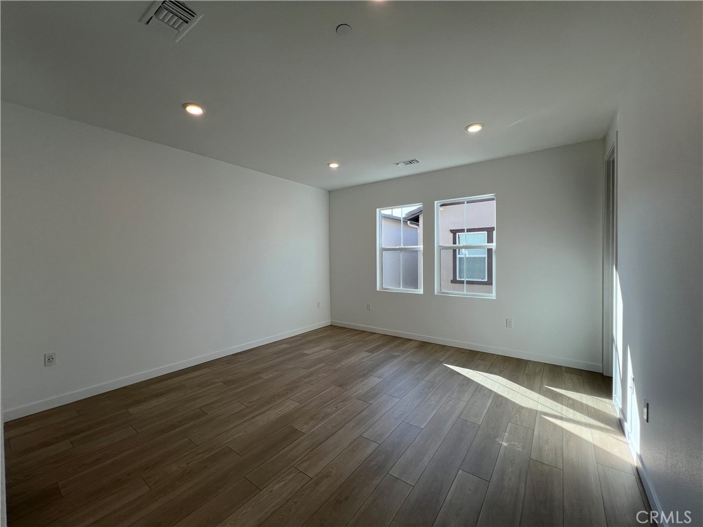 2543 Dorris Street El Monte, CA 91733 - Photo 10 of 13 an empty room with wooden floor and windows