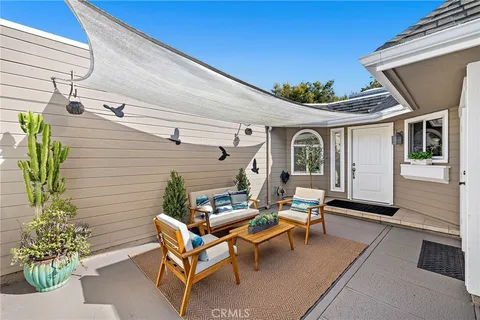 a view of a patio with table and chairs and potted plants