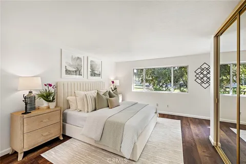 a bedroom with a large bed and a window