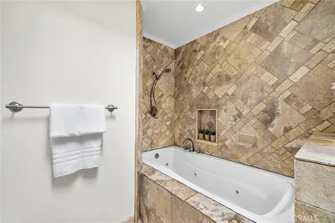 a bathroom with a tub and a shower