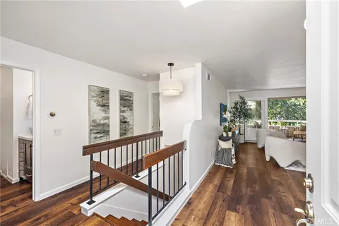 a view of a room with wooden floor windows and outdoor view