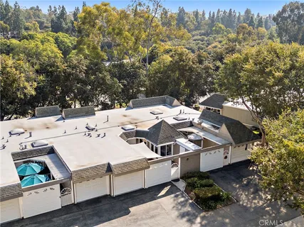 a view of a patio with table and chairs under an umbrella