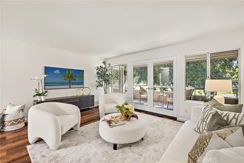 a living room with furniture a flat screen tv and a large window