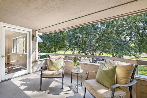 a balcony with furniture and garden view