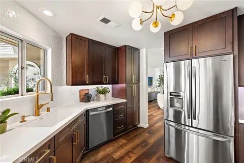 a kitchen with a refrigerator sink and cabinets