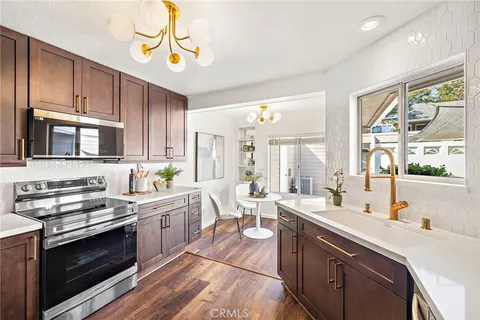 a kitchen with a sink stove and microwave