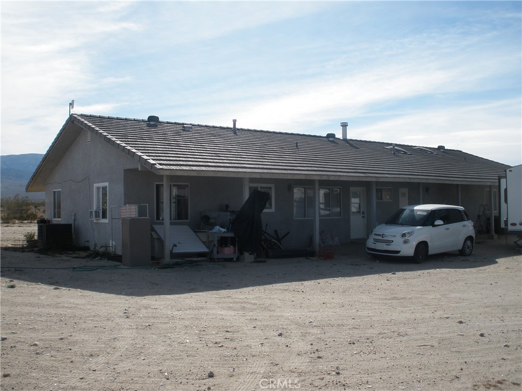 39036 Sage Road Lucerne Valley, CA 92356 - Photo 17 of 41 a view of a car parked in front of house