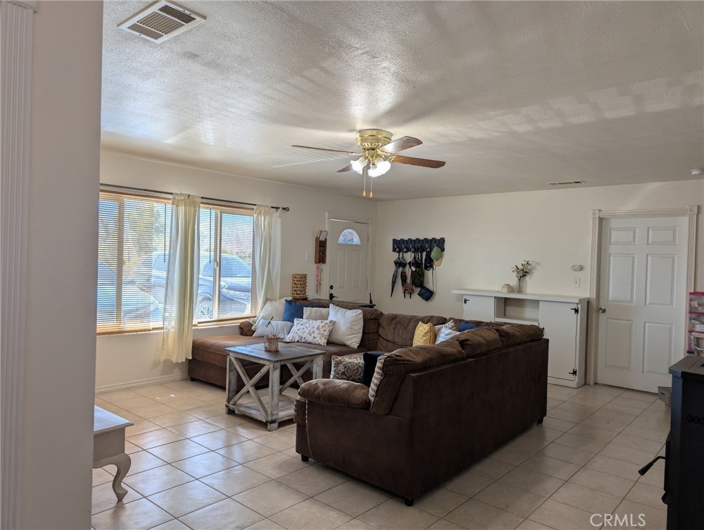 39036 Sage Road Lucerne Valley, CA 92356 - Photo 2 of 41 a living room with furniture and a large window