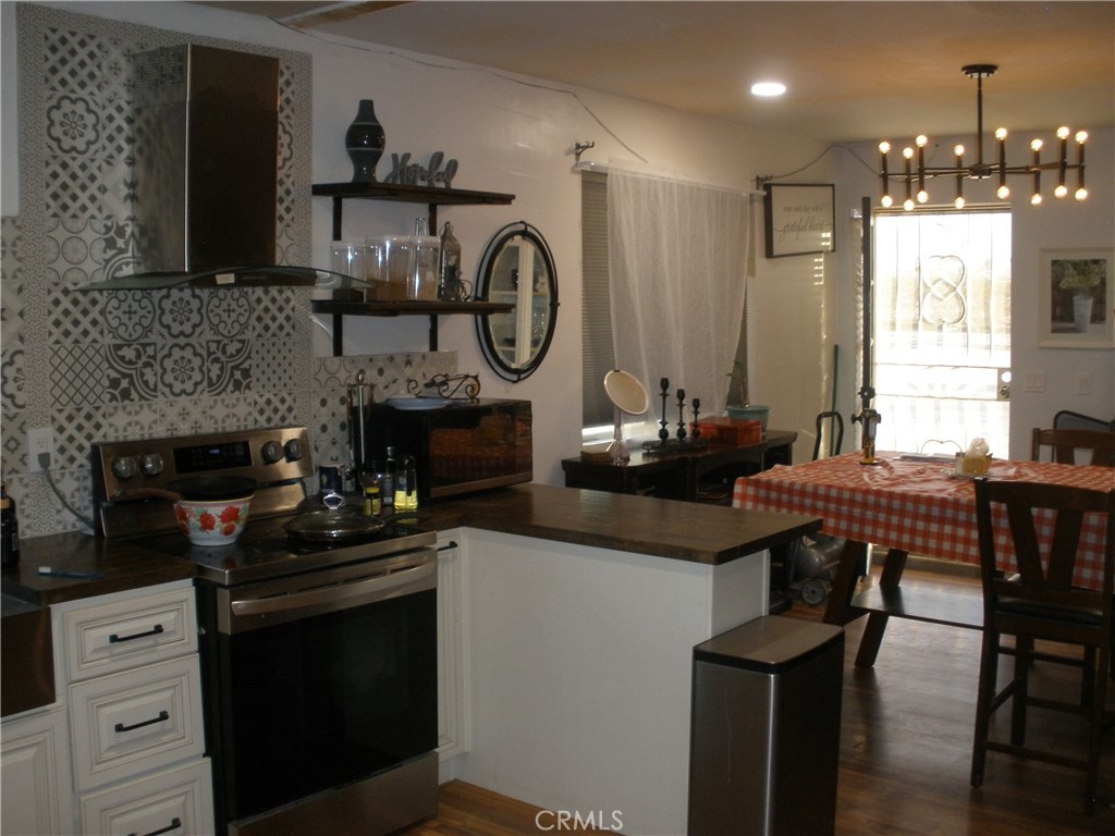 39036 Sage Road Lucerne Valley, CA 92356 - Photo 24 of 41 a kitchen with a stove and a table