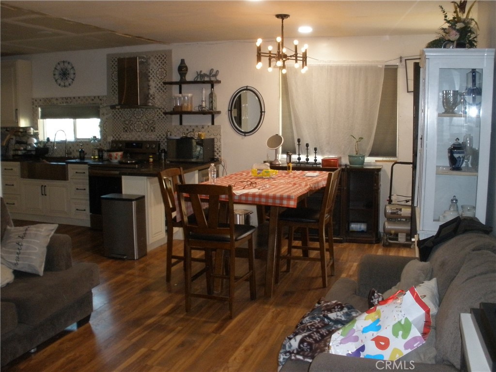 39036 Sage Road Lucerne Valley, CA 92356 - Photo 25 of 41 a view of a dining room with furniture and wooden floor