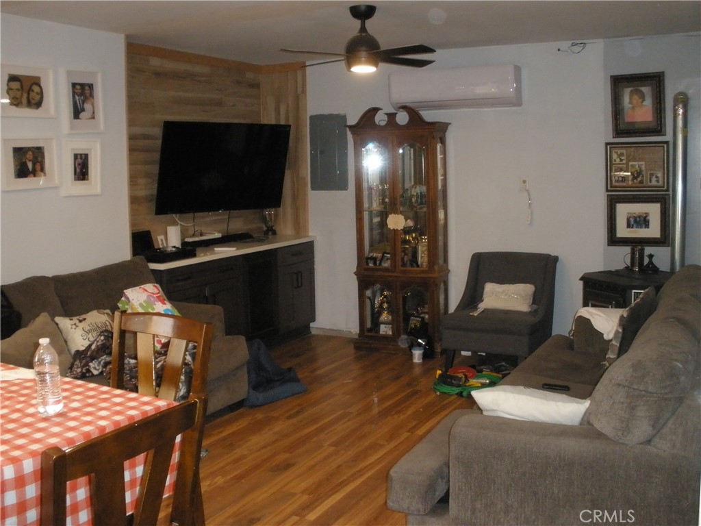 39036 Sage Road Lucerne Valley, CA 92356 - Photo 28 of 41 a living room with furniture and a flat screen tv