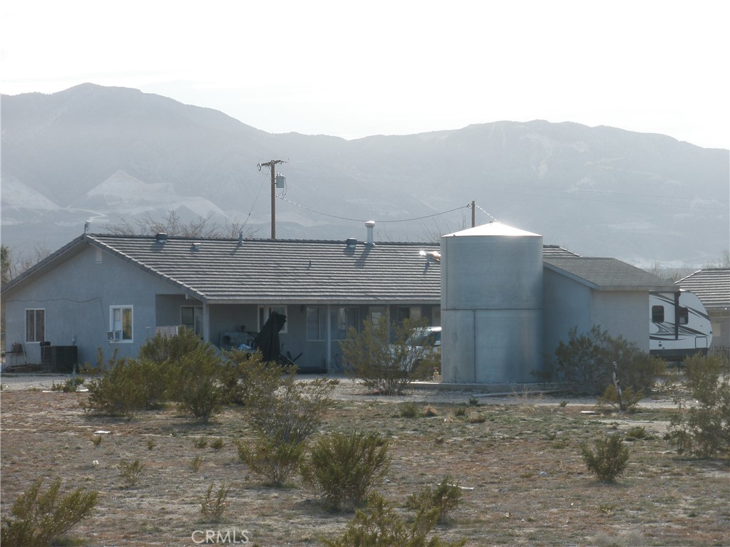 39036 Sage Road Lucerne Valley, CA 92356 - Photo 37 of 41 a view of a house with a yard and large tree