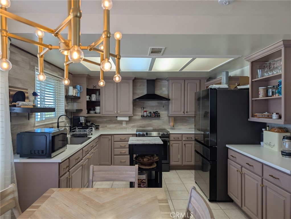 39036 Sage Road Lucerne Valley, CA 92356 - Photo 5 of 41 a kitchen with stainless steel appliances granite countertop a sink a stove and a refrigerator