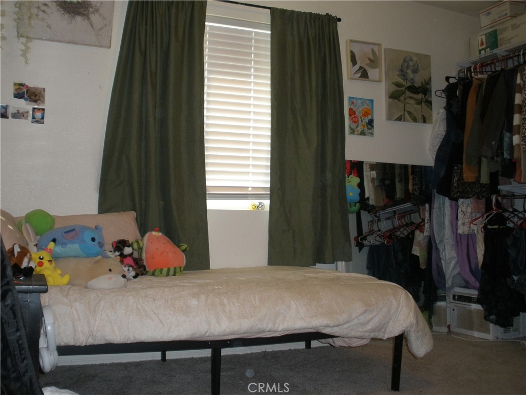 39036 Sage Road Lucerne Valley, CA 92356 - Photo 9 of 41 a bedroom with a bed and a window