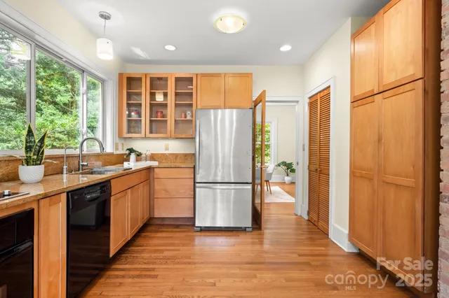 a kitchen with stainless steel appliances granite countertop a refrigerator and a sink