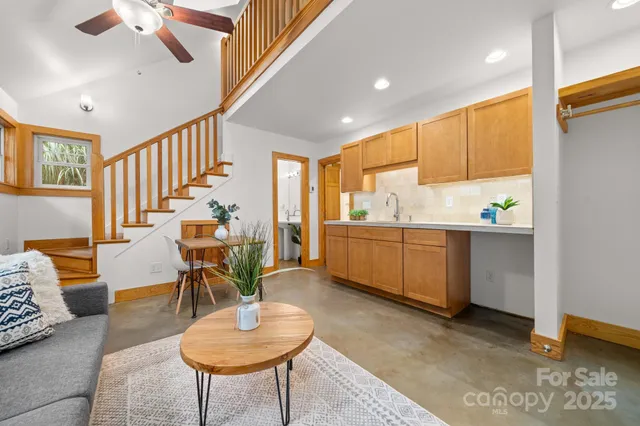 a view of a dining room with furniture a rug and wooden floor
