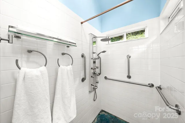 a bathroom with a shower and a mirror