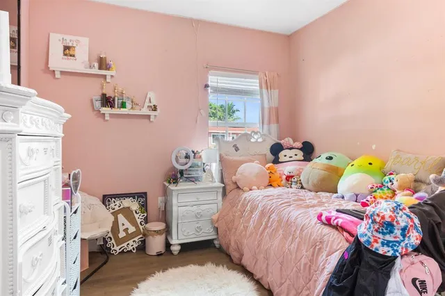 a bed room with two beds and a baby crib