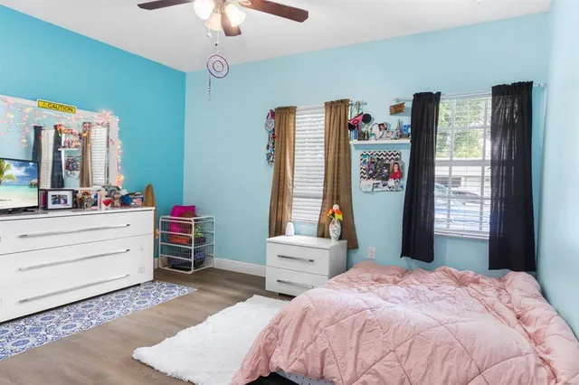 a bedroom with a bed dresser and a window