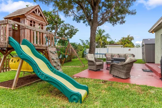 a view of a backyard with sitting area