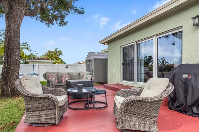 a view of a patio with couches chairs and a potted plant